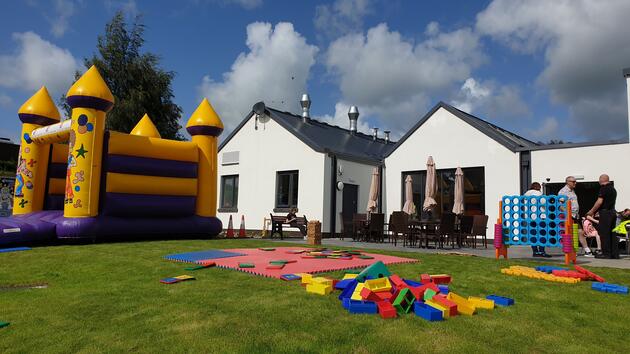 Outdoor events outside Ochiltree Community Hub, with games and a bouncy castle.